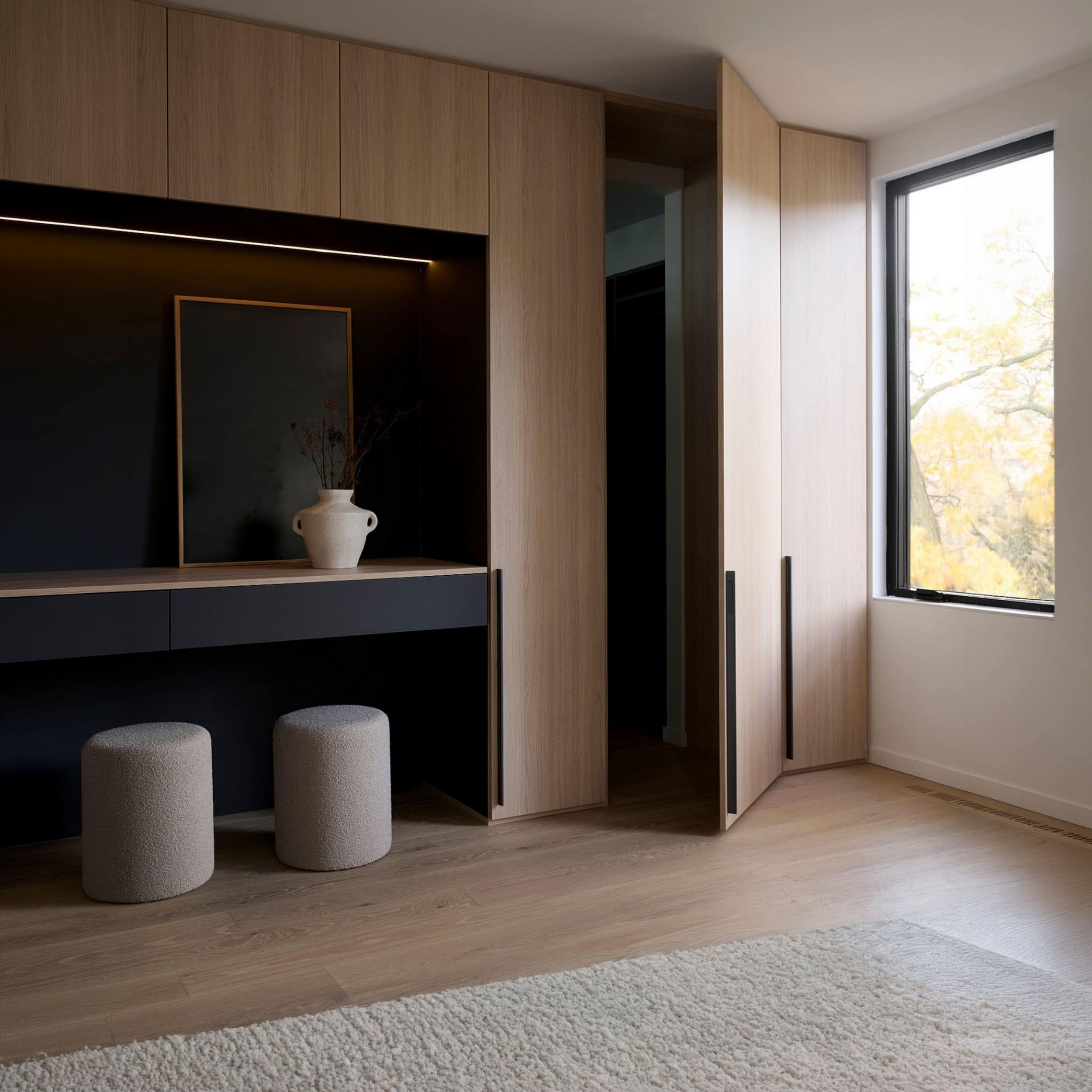 Interior view of a modern interior with wooden cabinets and large window in sustainable architecture in The Beaches, Toronto by baukultur/ca