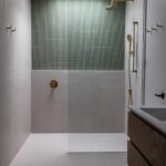 Walk-in shower with tile accent wall at Haus A36 — multiplex with laneway suite in Playter Estates, Toronto by baukultur/ca.