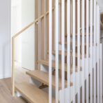 Oak stair with vertical baluster railing at Haus A36 — multiplex with laneway suite in Playter Estates, Toronto by baukultur/ca.