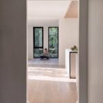 Home A living area through a doorway at Haus L1 — multigenerational multiplex renovation in The Beaches, Toronto by baukultur/ca.